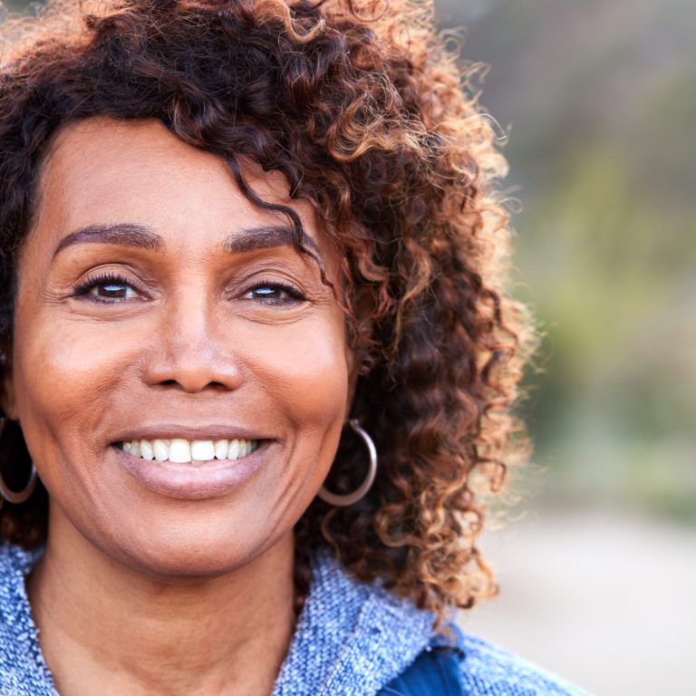 Portrait Of Smiling African American Senior Woman Outdoors In Countryside
